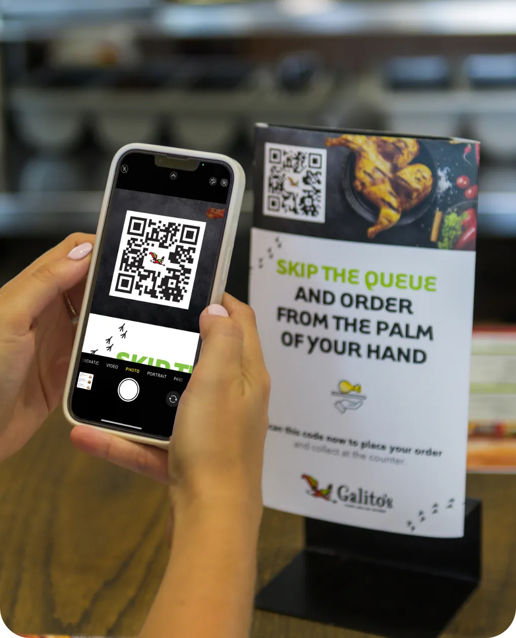 Customer scanning a Galito's skip-the-queue QR code on a table talker