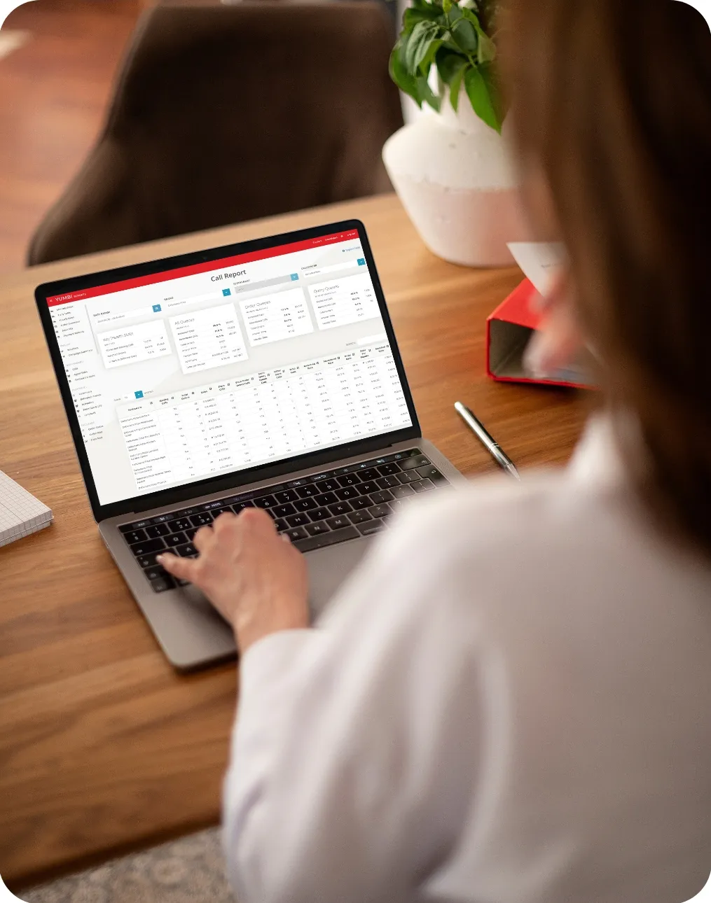 Analyst reviewing a YUMBI Insights report on a laptop